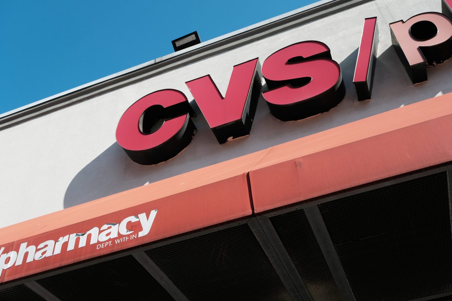 A red CVS pharmacy sign on the side of a building