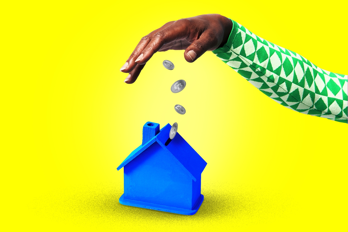 Photo illustration of a woman's hand dropping coins into a small blue wooden house with a coin slot in the roof.